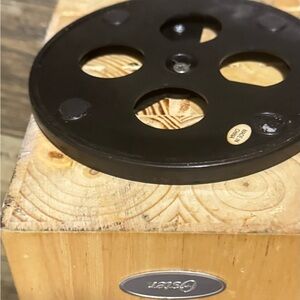 Oster Silver Logo on Wooden Surface